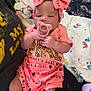 Angel joined the competition — help win amazing prizes! baby, infant, pacifier, pink_outfit, headband, bow, person, clothing, sitting, hand, blanket, bed, fabric, pattern, text_on_clothing, indoor, adult_arm, comfort, cute, resting