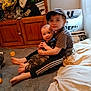 River joined the competition — help win amazing prizes! child, baby, carpet, clothing, couch, floor, furniture, hug, indoor, person, portrait, room, sitting, smile, toy, wooden_cabinet, hat, bag, blanket, casual