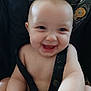 River is registered to the contest to win money with this photo: baby, smiling, infant, car_seat, safety_strap, happy, child, cute, face, cheerful, seat, young, portrait, person, skin, blue_eyes, expression, childhood, indoors, seatbelt