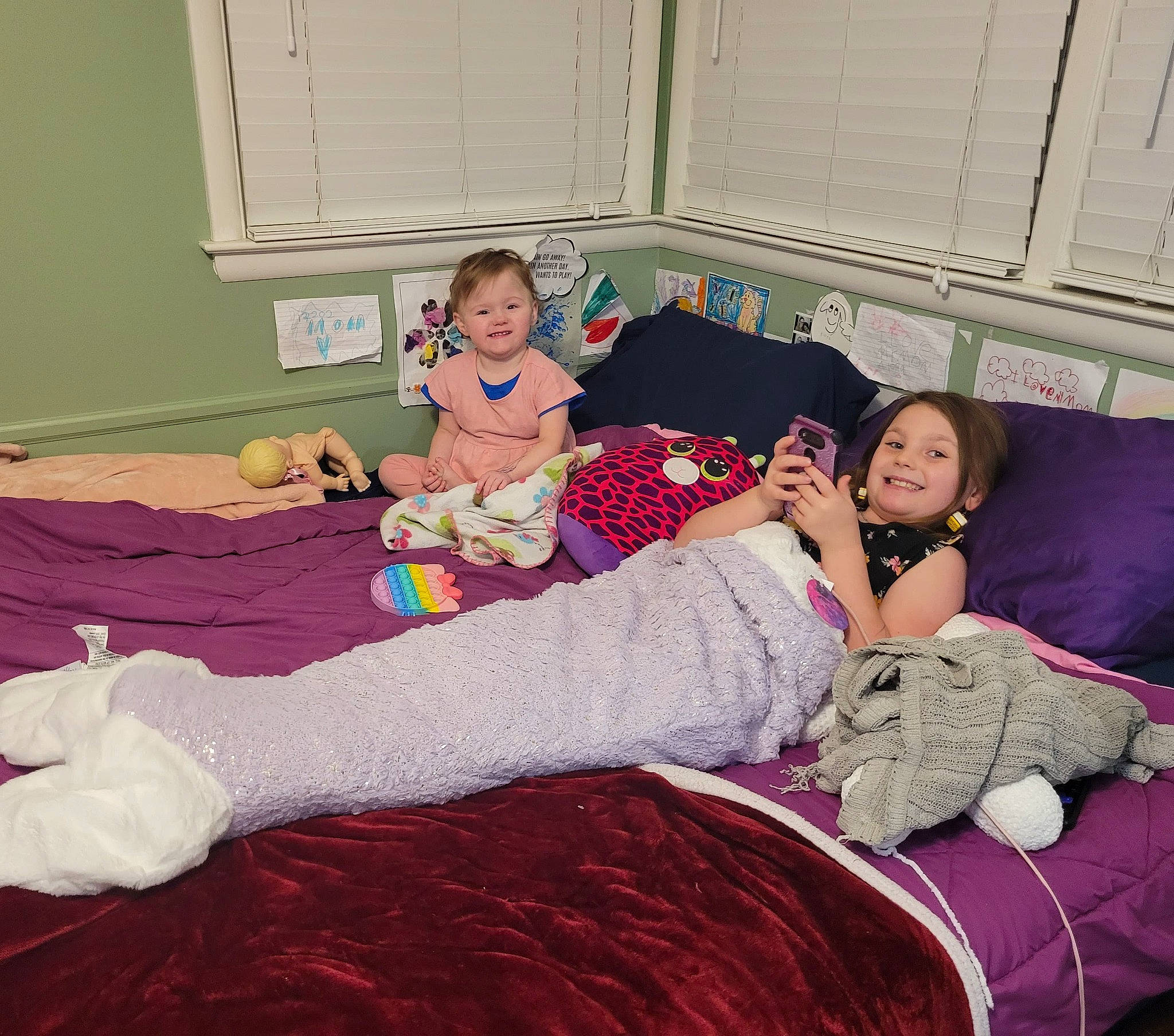 Aliza joined the competition — help win amazing prizes! bed, bedding, bedroom, child, comfort, event, floor, flooring, fun, happy, human_leg, joy, knee, lap, linens, magenta, person, pink, purple, textile