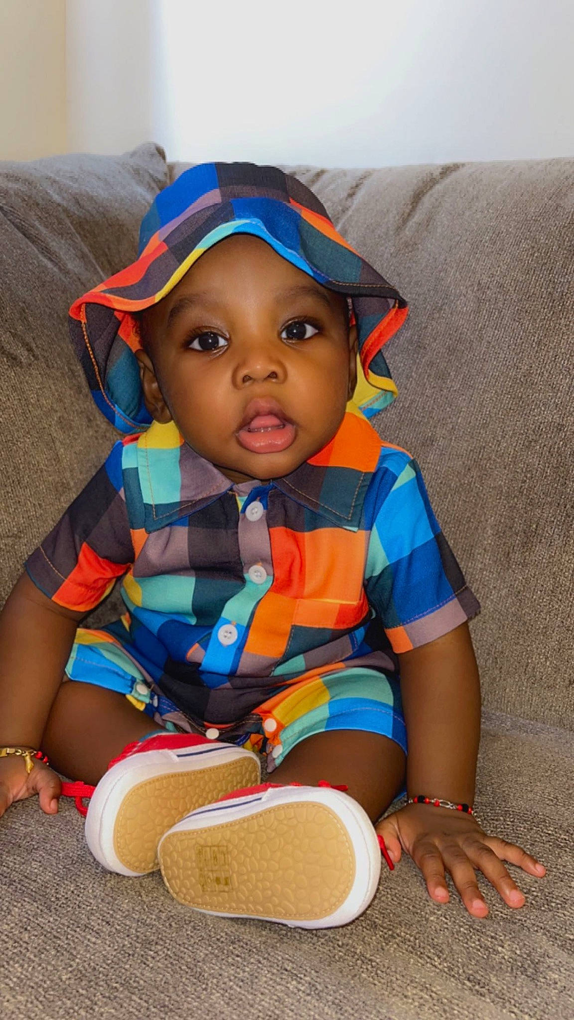 Aiden is registered to the contest to win money with this photo: baby, baby_products, baby_toddler_clothing, child, comfort, doll, electric_blue, eye, fashion_accessory, fun, hat, headwear, nose, orange, person, personal_protective_equipment, sitting, skin, sleeve, toddler