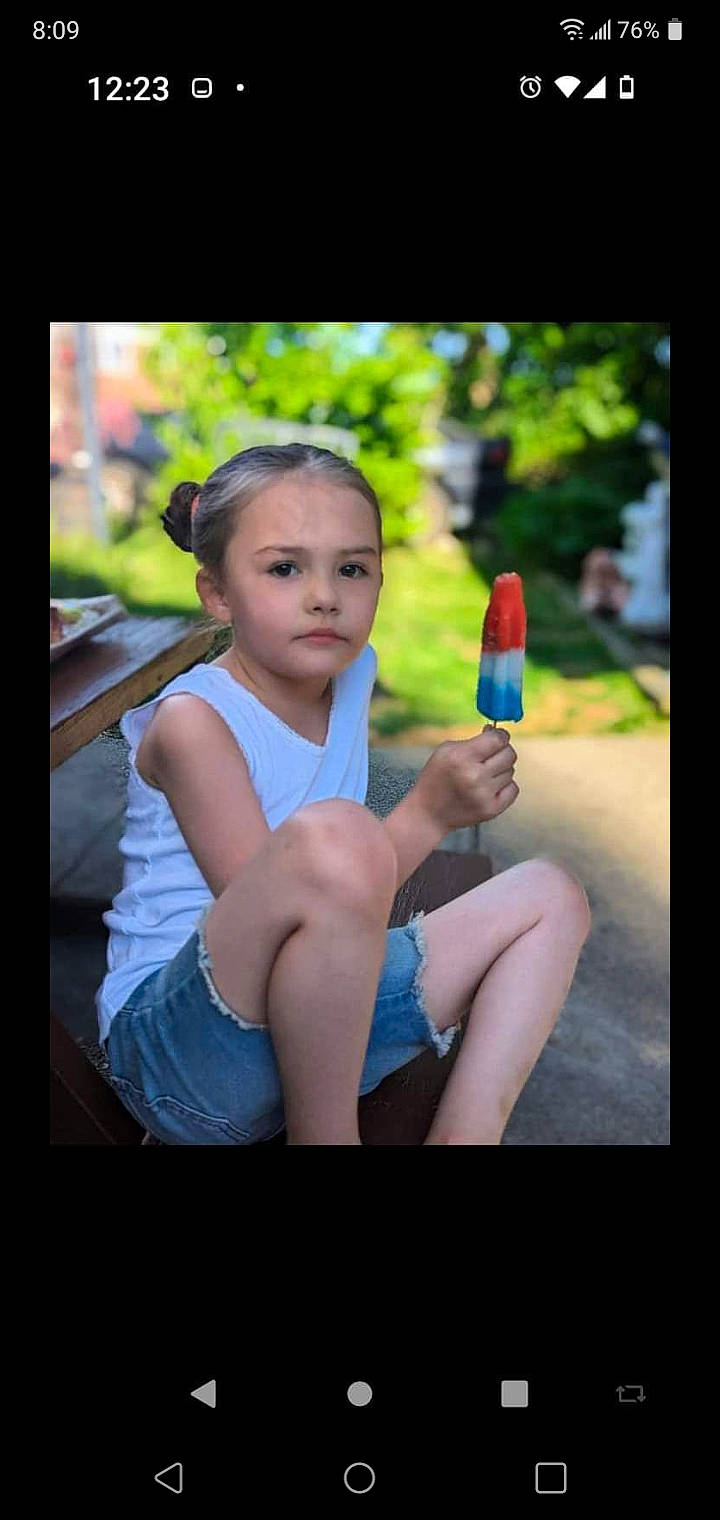 Saydabell is registered to the contest to win money with this photo: child, communication_device, cool, electric_blue, flash_photography, foot, fun, gesture, grass, happy, human_leg, leisure, person, plant, recreation, shorts, sitting, t_shirt, thigh, toddler