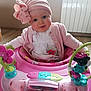 Louise participe au concours pour gagner de l'argent avec cette photo : baby, baby_walker, blue_eyes, bow, child, clothing, curious, cute, face, floor, hat, indoor, person, pink, playful, radiator, sitting, smile, toy, window