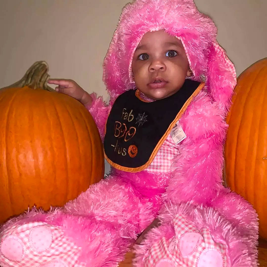 Lailani joined the competition — help win amazing prizes! baby, baby_toddler_clothing, calabaza, eye, facial_expression, gourd, head, headwear, iris, magenta, natural_foods, orange, organ, outerwear, person, pink, pumpkin, purple, squash, toddler