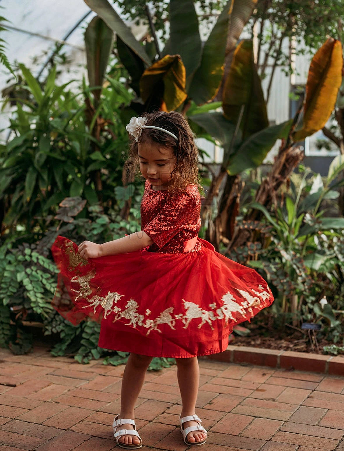 Mirabella is registered to the contest to win money with this photo: baby_toddler_clothing, costume, dress, entertainment, event, face, fun, happy, headgear, leaf, leisure, magenta, performing_arts, person, plant, ruffle, sandal, smile, toddler, tradition