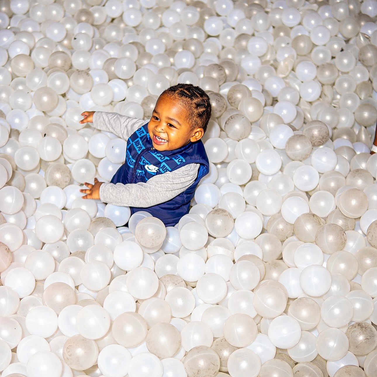 Khari joined the competition — help win amazing prizes! ball_pit, braided_hair, child, cute, dirty_balls, excited, fun, happy, indoor, joy, long_sleeve_shirt, person, plastic_balls, play, play_area, recreation, smiling, toddler, vest, white_balls