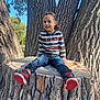 Kameron joined the competition — help win amazing prizes! child, smiling, tree_stump, tree_bark, outdoor, nature, blue_sky, striped_shirt, jeans, sneakers, red_shoes, casual_clothing, sunlight, daylight, park, happy, sitting, person, young_child, playful