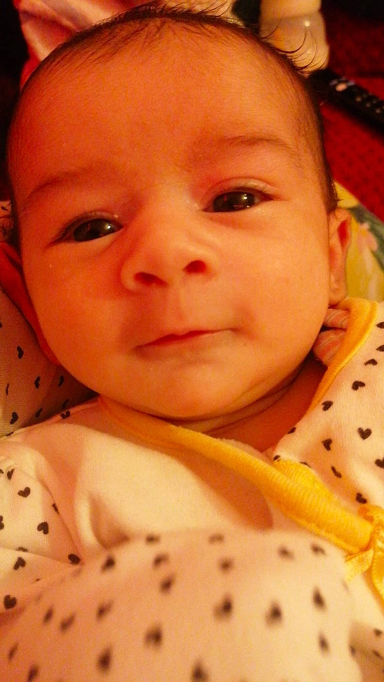 Amber is registered to the contest to win money with this photo: baby, baby_toddler_clothing, cheek, child, chin, close_up, collar, eyebrow, eyelash, face, facial_expression, happy, iris, lip, nose, pattern, person, product, skin, sleeve