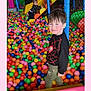 ball_pit, blue, casual_clothing, child, climbing, colorful, fence, fun, green, happy, indoor, kid, orange, pink, plastic_balls, play, playground, slide, smile, yellow