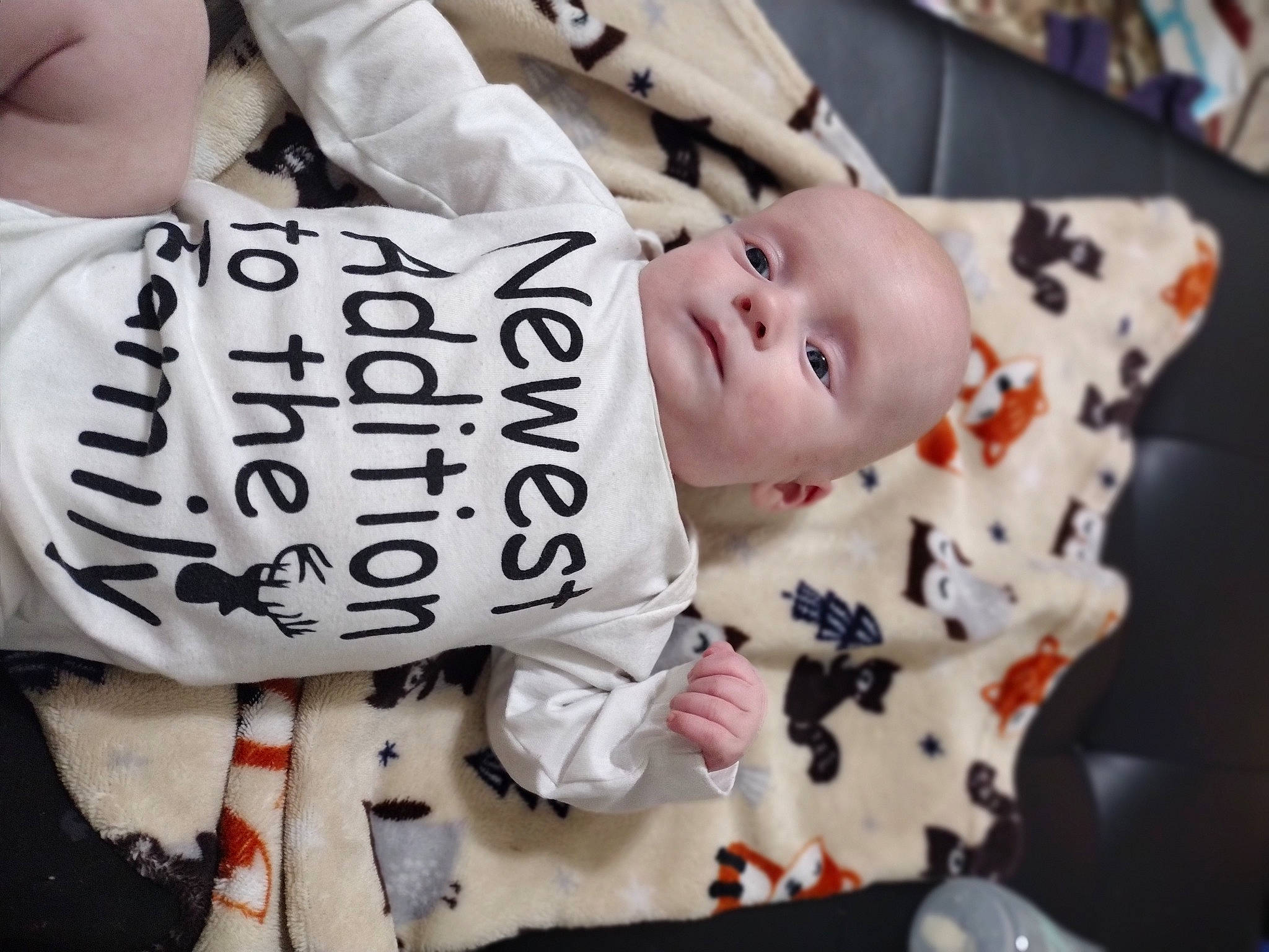 Osiris is registered to the contest to win money with this photo: baby, baby_products, baby_toddler_clothing, cheek, chest, child, comfort, elbow, facial_expression, font, handwriting, happy, linens, pattern, person, pink, room, sitting, sleeve, textile