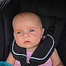 Ivy is registered to the contest to win money with this photo: baby, blue_eyes, car_seat, child, colorful_toys, face, harness, infant, inside, looking_away, play, pink_clothing, seatbelt, sitting, toy, young_child, young_infant, black_car_seat, closeup, portrait