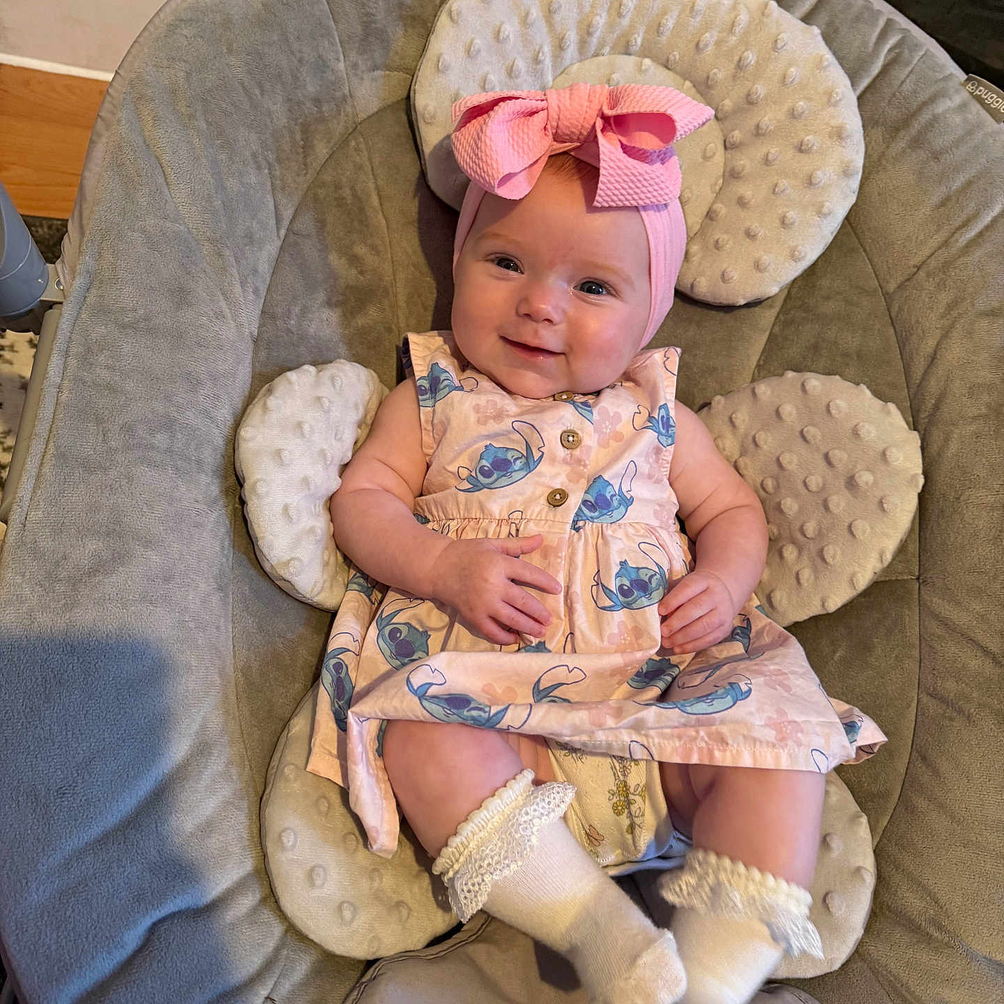 Lilah-Mae joined the competition — help win amazing prizes! adorable, baby, baby_seat, blue_pattern, child, cushioned_seat, cute, dress, happy, headband, indoor, infant, person, pink_bow, relaxed, small_hands, smiling, socks, soft_texture, white_socks