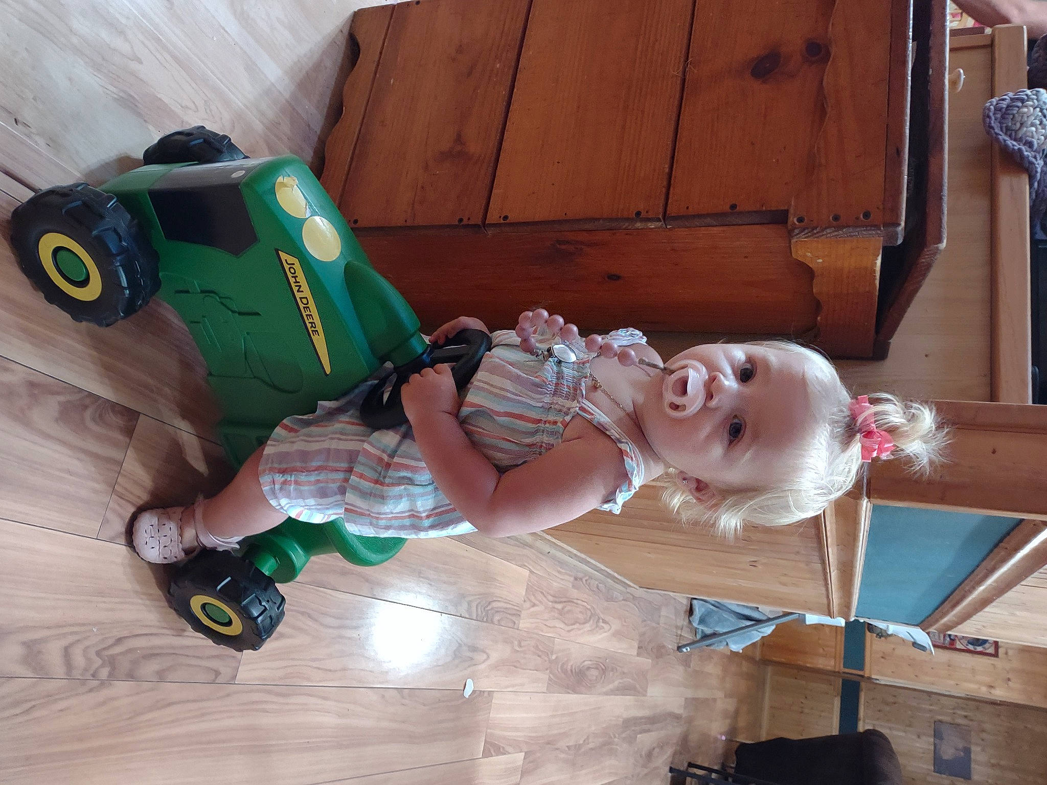 Alaya is registered to the contest to win money with this photo: baby, baby_products, baby_toddler_clothing, baby_toys, child, fictional_character, flooring, fun, person, personal_protective_equipment, plastic, play, sitting, smile, stuffed_toy, toddler, toy, toy_vehicle, wood