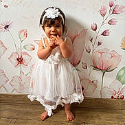 Juliette participe au concours pour gagner de l'argent avec cette photo : baby, barefoot, child, cute, fashion, floral_wallpaper, happy, headband, indoor, innocent, person, playful, portrait, small, smiling, standing, toddler, white_dress, wooden_floor, young_child