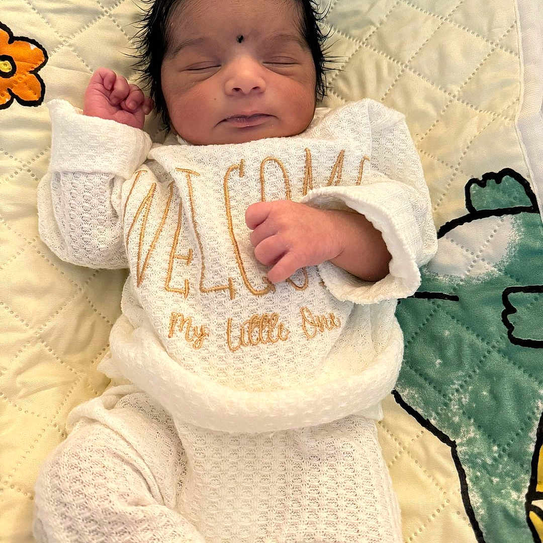 Ayan joined the competition — help win amazing prizes! baby, baby_clothes, bedtime, child, closed_eyes, cozy, cute, cuteness, decorative_blanket, embroidered_text, face, hand, infant, lying_down, newborn, peaceful, quilted_blanket, sleeping, soft_texture, white_outfit