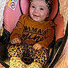 Natalie joined the competition — help win amazing prizes! baby, infant, smiling, leopard_print, headband, brown_shirt, stroller, pink_cushion, cozy, cute, child, footwear, socks, happy, portrait, indoors, person, seated, clothing, baby_clothes