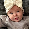 baby, infant, child, headband, bow, knitwear, sweater, cute, face, portrait, smile, eyes, skin, expression, cozy, warm_clothing, indoor, texture, background, soft_lighting