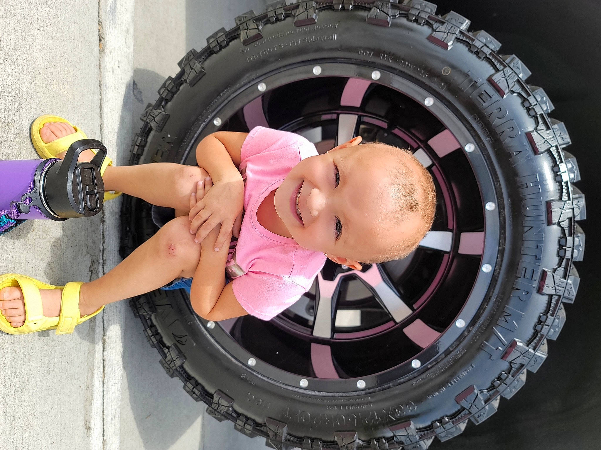 Brylee joined the competition — help win amazing prizes! arm, audio_equipment, auto_part, automotive_design, automotive_tire, automotive_wheel_system, flash_photography, fun, glasses, hat, headgear, joy, person, pink, product, rim, spoke, tire, tire_care, toddler