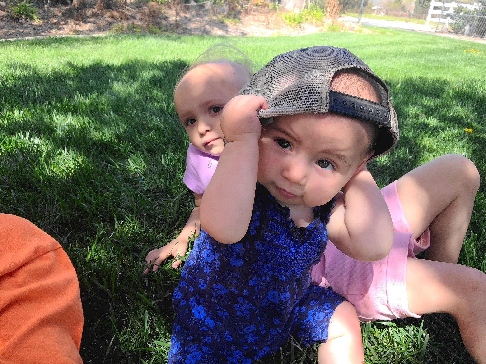 Harlee is registered to the contest to win money with this photo: baby, baby_toddler_clothing, botany, dress, face, fun, grass, happy, headwear, iris, leaf, leisure, mammal, people_in_nature, person, pink, plant, public_space, skin, sunlight