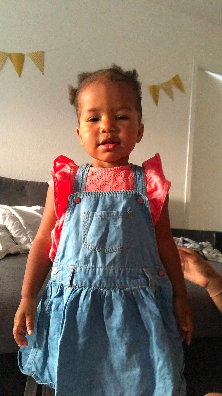 Ramata participe au concours pour gagner de l'argent avec cette photo : arm, baby_toddler_clothing, cheek, day_dress, dress, eye, face, fashion_design, formal_wear, hair, head, neck, one_piece_garment, person, shoulder, skin, sleeve, standing, toddler, trunk