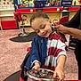 Anthony joined the competition — help win amazing prizes! child, barbershop, haircut, steering_wheel, red_chair, mirror, person, smile, happy, indoor, playful, hairdresser, combed_hair, floor, reflection, colorful, cape, hands, young, fun