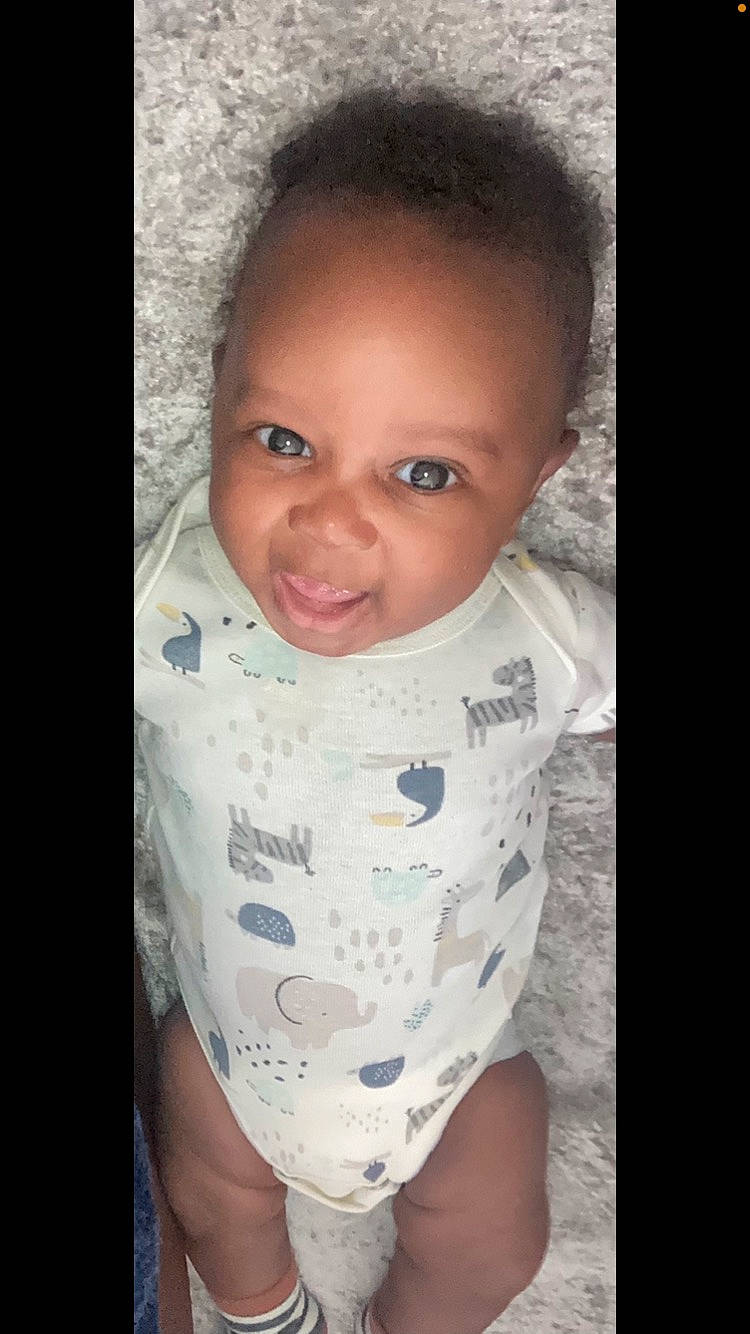 Cairo is registered to the contest to win money with this photo: arm, baby, baby_toddler_clothing, cheek, chin, eyebrow, eyelash, flash_photography, forehead, hand, happy, human_body, iris, lip, mouth, neck, nose, person, skin, sleeve