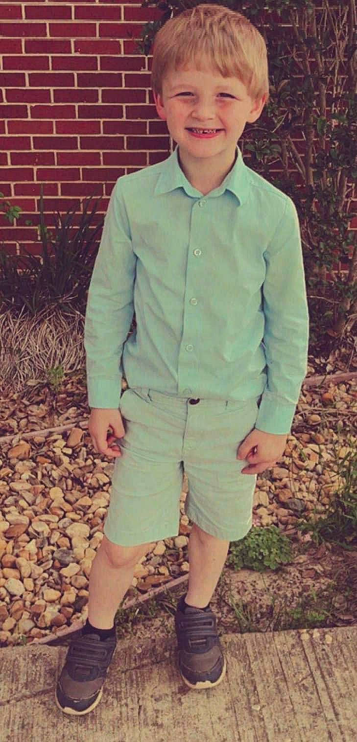 Sebastian is registered to the contest to win money with this photo: baby_toddler_clothing, blazer, clothing, collar, cool, denim, dress_shirt, hairstyle, happy, human, joy, knee, outerwear, person, shorts, sleeve, smile, standing, t_shirt, thigh