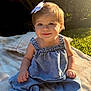Ellie is registered to the contest to win money with this photo: baby, blanket, bow, casual, child, clothing, cute, daylight, denim, face, grass, happy, nature, outdoor, portrait, sitting, smiling, sunlight, toddler, young_child