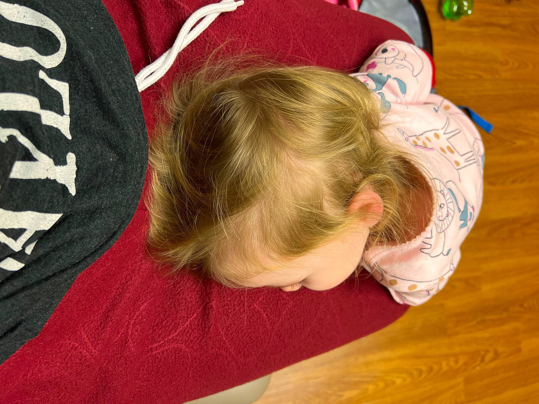 Madilyn is registered to the contest to win money with this photo: baby, carmine, child, comfort, elbow, flooring, fun, hardwood, pattern, person, play, room, sitting, sleeve, t_shirt, toddler, varnish, wood, wood_flooring