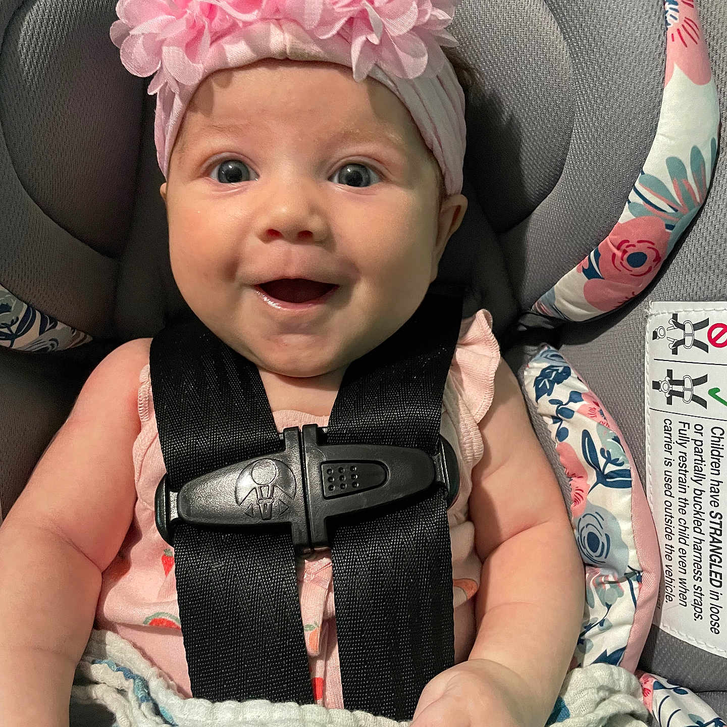 Delilah is registered to the contest to win money with this photo: accessories, baby, babylaughing, belt, cap, car, car_interior, clothing, cushion, face, happy, hat, head, homedecor, person, photography, portrait, smile, transportation, vehicle