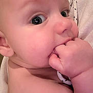 Jeremiah is registered to the contest to win money with this photo: baby, close_up, infant, hand, skin, face, chewing, curious, eyes, cute, fist, polka_dot, fabric, soft, child, portrait, expression, mouth, skin_tone, newborn