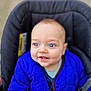 baby, blue_eyes, blue_jacket, car_seat, child, cute, face, infant, jacket, person, portrait, seat, smile, young_child, happy, warm_clothing, indoor, closeup, cozy, baby_toy