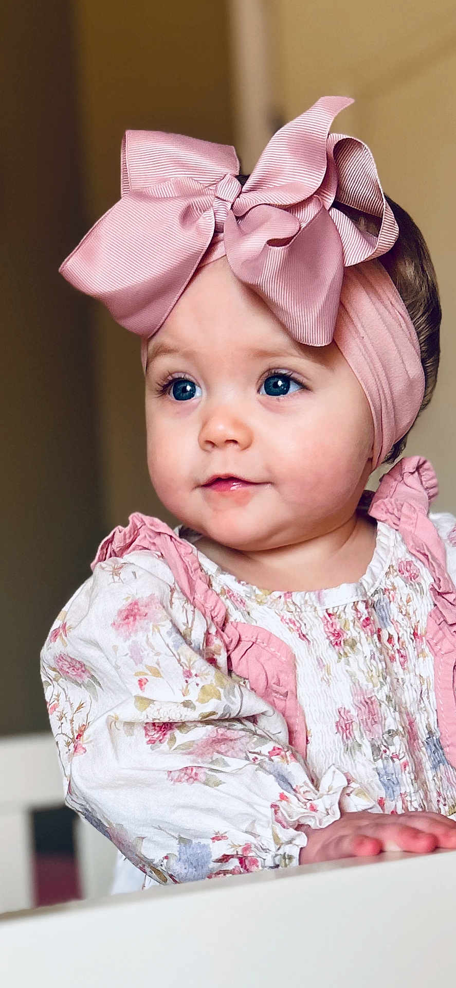Laramie Kate joined the competition — help win amazing prizes! baby, infant, toddler, headband, bow, pink_bow, blue_eyes, portrait, closeup, floral_dress, ruffles, cheeks, rosy_cheeks, hands, indoor, soft_lighting, cute, eyelashes, fashion, smiling