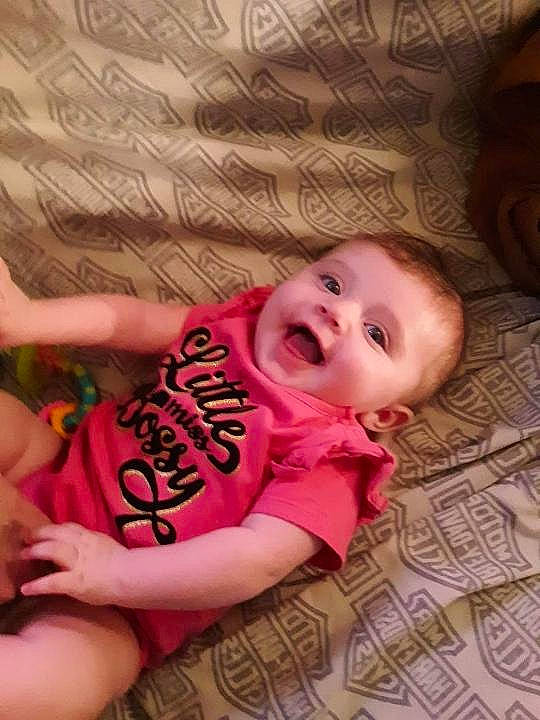 Alayna is registered to the contest to win money with this photo: baby_toddler_clothing, cheek, chin, eye, eyebrow, face, facial_expression, hair, hairstyle, hand, head, human, human_body, leg, mouth, nose, organ, person, skin, stomach