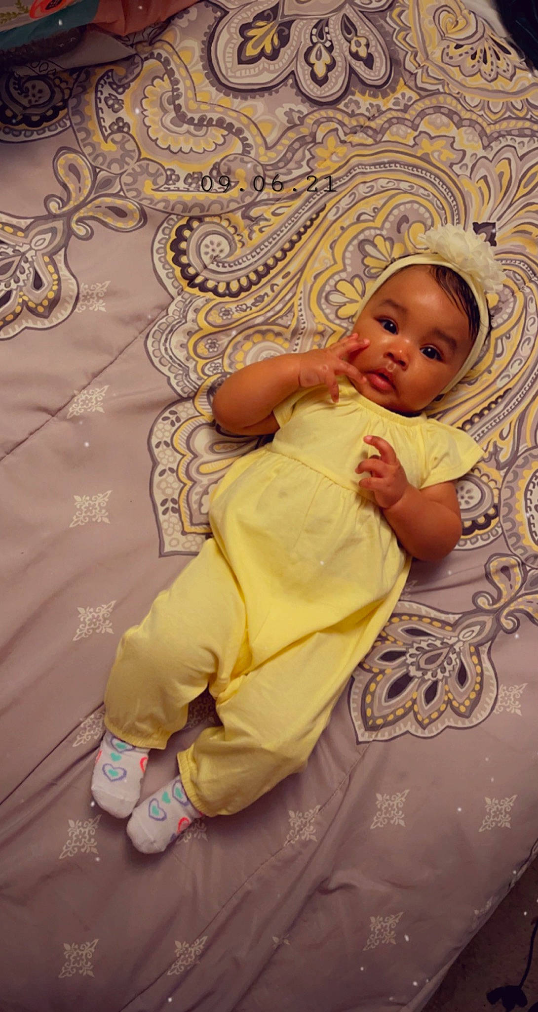 Kassidy is registered to the contest to win money with this photo: art, baby, baby_toddler_clothing, cheek, child, comfort, event, eye, face, flooring, gesture, hand, happy, head, linens, pattern, person, pink, skin, textile