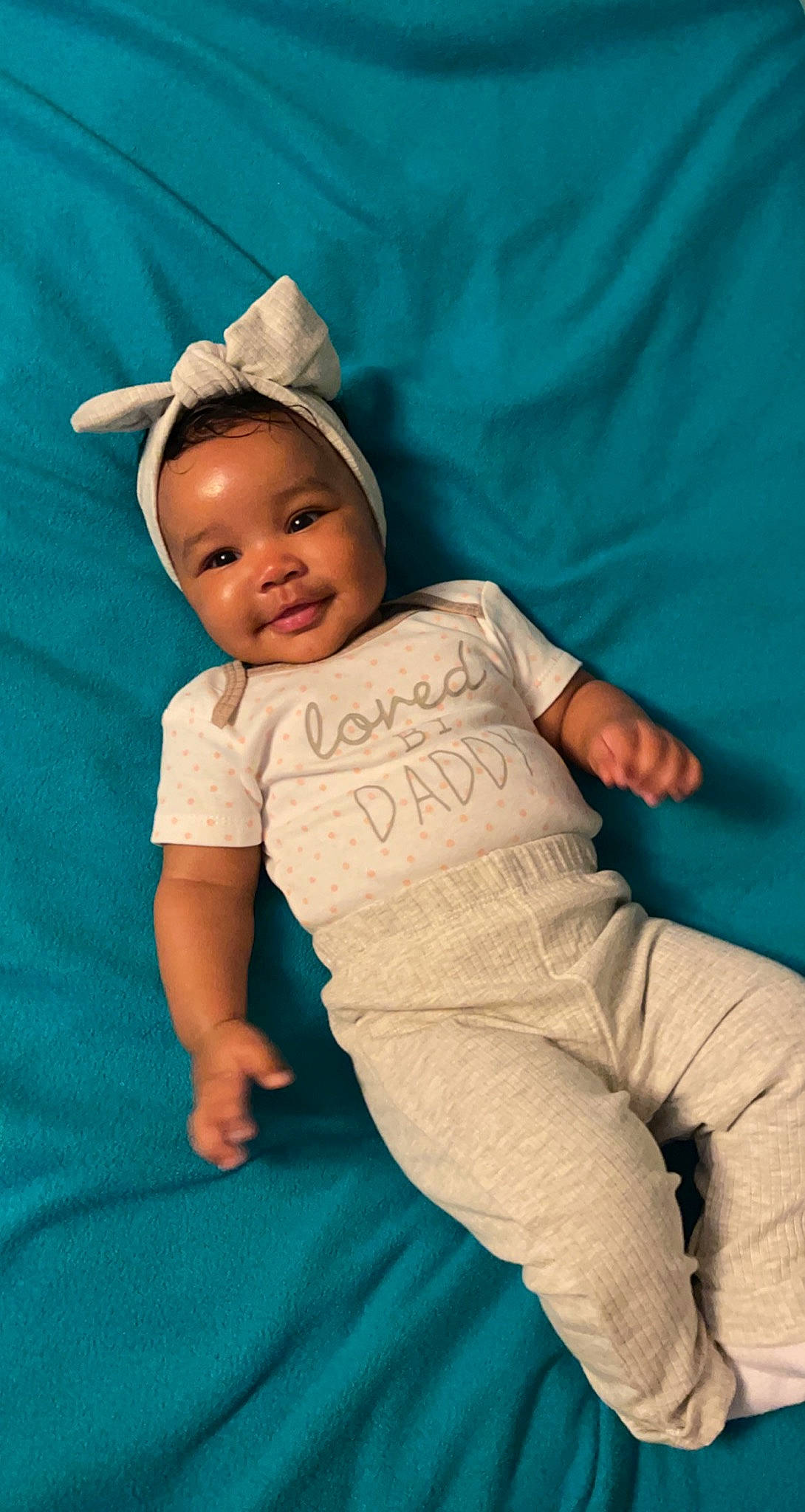 Kassidy is registered to the contest to win money with this photo: azure, baby, baby_toddler_clothing, cap, child, comfort, elbow, electric_blue, fun, happy, hat, human_leg, linens, person, pink, skin, sleeve, smile, t_shirt, textile