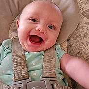 Hazel is registered to the contest to win money with this photo: baby, baby_seat, buckle, cheeks, child, closeup, eyes, fabric_pattern, face, happy, head, infant, mouth_open, onesie, polka_dots, portrait, seat_harness, skin, smiling, strap