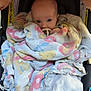 baby, blanket, car_seat, child, infant, pacifier, blue_eyes, wrapped, cozy, patterned_blanket, snug, cute, indoor, soft, comfort, young_child, car_seat_strap, face, head, clothing