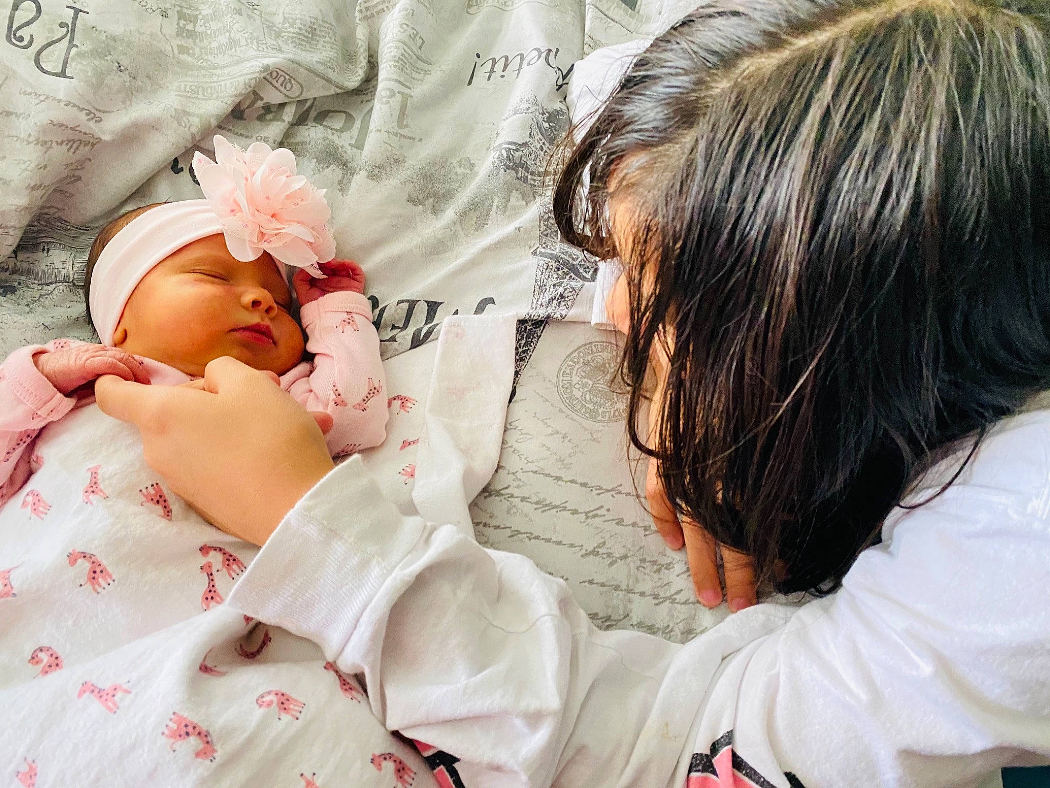 Vanellope is registered to the contest to win money with this photo: baby_sleeping, child, comfort, eyelash, facial_expression, gesture, hair, hairstyle, hand, happy, headwear, interaction, linens, lip, mammal, neck, person, petal, skin, sleeve