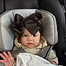 Elianna is registered to the contest to win money with this photo: baby, car_seat, headband, bow, blanket, infant, child, clothing, person, seatbelt, blue_eyes, cute, indoor, soft_lighting, apparel, young_child, hand, expression, face, portrait