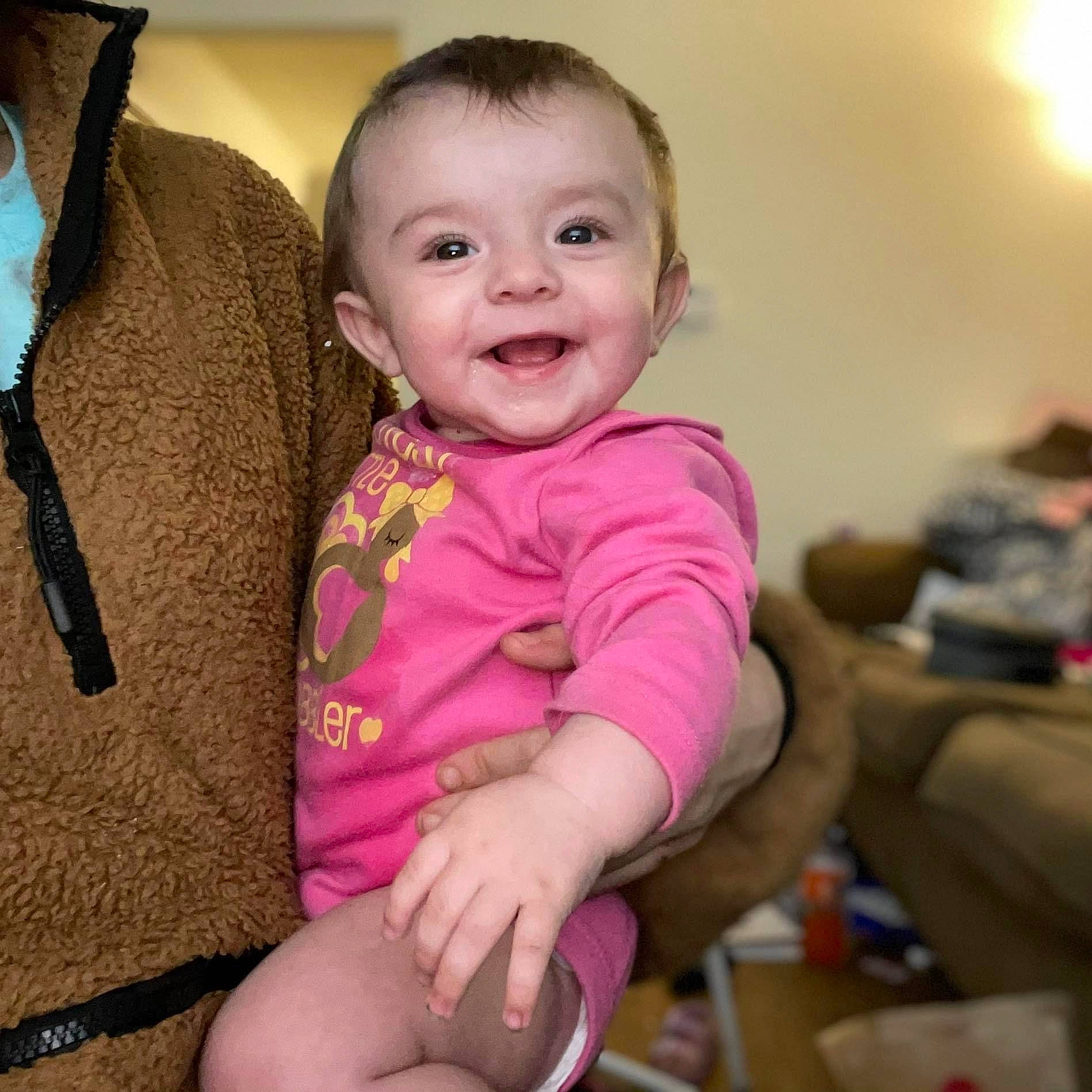 Annalee is registered to the contest to win money with this photo: baby, baby_toddler_clothing, cheek, comfort, eye, face, finger, fun, happy, head, iris, joy, neck, nose, person, pink, shoulder, skin, sleeve, smile