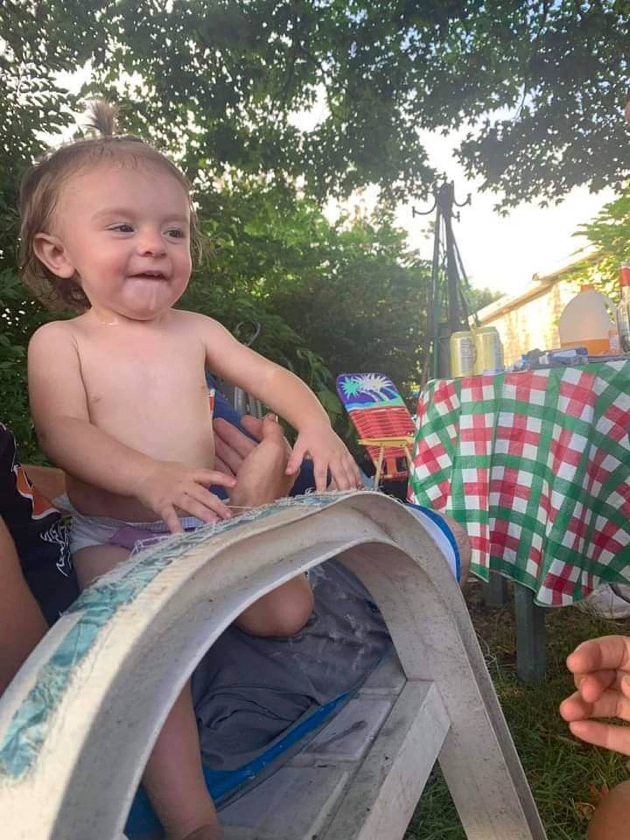 Annalee is registered to the contest to win money with this photo: auto_part, automotive_wheel_system, barechested, child, event, fun, grass, happy, joy, leisure, pattern, person, recreation, sitting, smile, t_shirt, thumb, toddler, tree, vacation