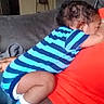 J'Hleel is registered to the contest to win money with this photo: baby, child, toddler, sleeping, cuddling, indoor, couch, sofa, adult, parent, striped_shirt, blue_clothing, red_clothing, socks, curly_hair, resting, portrait, family, cozy, home