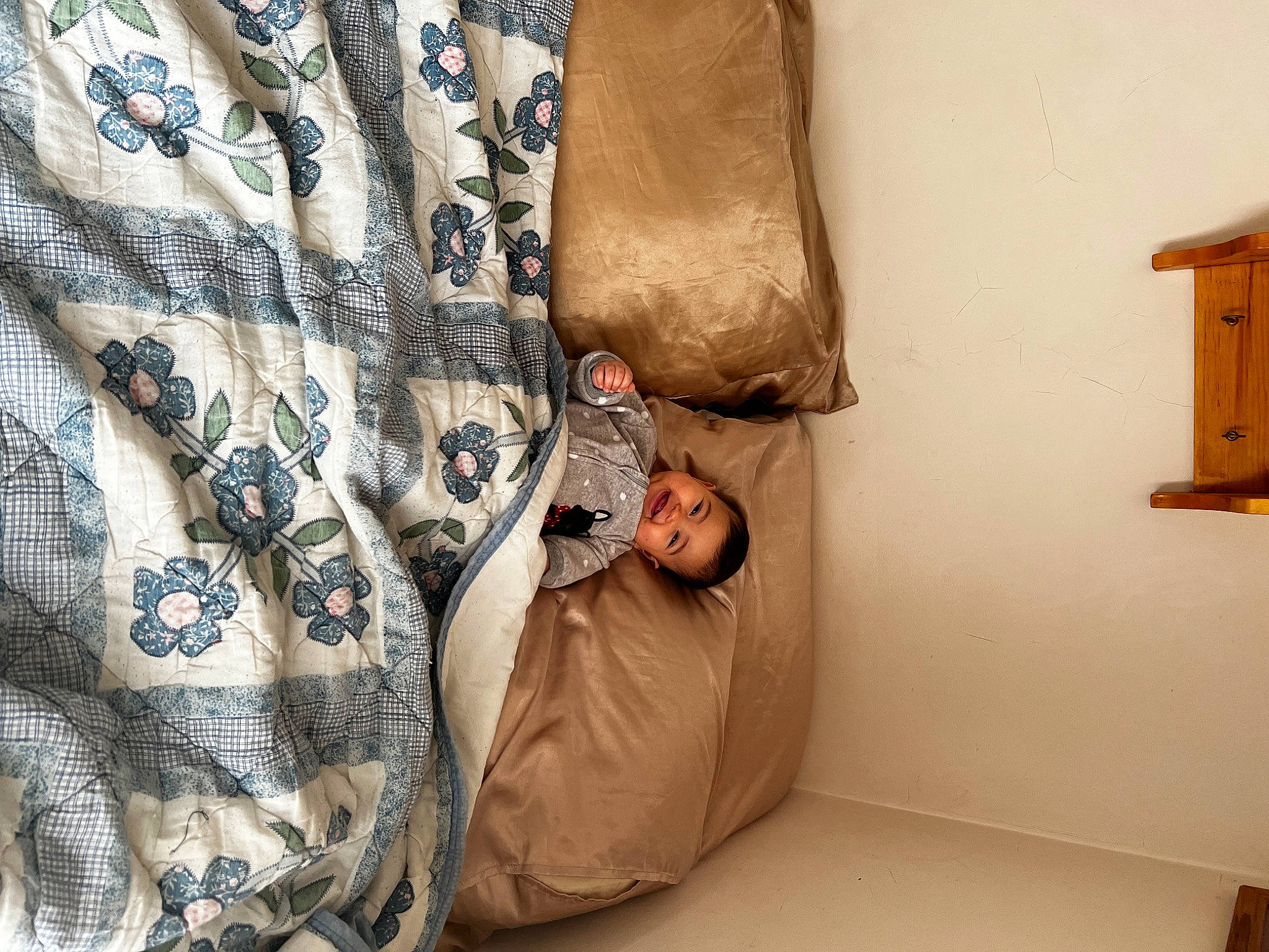 Althea is registered to the contest to win money with this photo: bag, bed_sheet, bedding, bedroom, comfort, couch, flooring, hardwood, house, human_leg, interior_design, joy, linens, military_camouflage, pattern, person, room, sleeve, thigh, throw_pillow