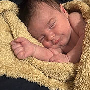 Remington joined the competition — help win amazing prizes! baby, sleeping, blanket, yellow_blanket, infant, cozy, soft_texture, peaceful, closeup, portrait, skin, cute, newborn, resting, hand, fist, lying_down, warm_lighting, indoors, comfort