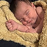 baby, sleeping, blanket, yellow_blanket, infant, cozy, soft_texture, peaceful, closeup, portrait, skin, cute, newborn, resting, hand, fist, lying_down, warm_lighting, indoors, comfort