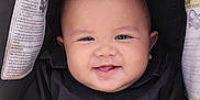 Harkin Hezekiah is registered to the contest to win money with this photo: arms, baby, black_shirt, buttoned_shirt, car_seat, child, close_up, cute, face, happy, head, indoor, infant, person, portrait, seat, seat_belt_warning, skin, smiling, young_child