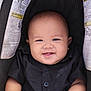 baby, infant, smiling, face, black_shirt, car_seat, child, happy, cute, portrait, young_child, seat_belt_warning, close_up, skin, person, arms, buttoned_shirt, indoor, head, seat