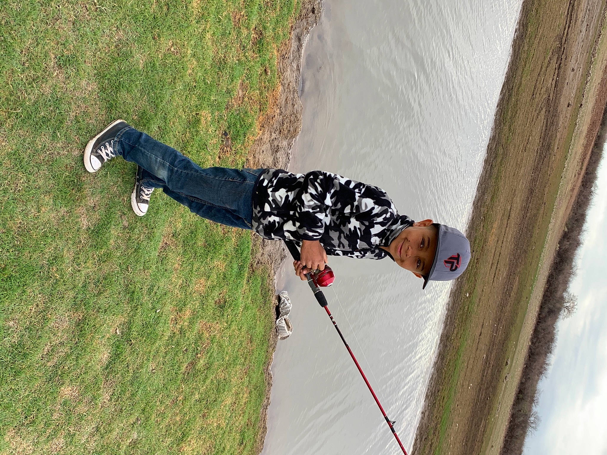 Davien is registered to the contest to win money with this photo: adventure, fun, grass, happy, headwear, joy, landscape, leisure, outdoor_shoe, people_in_nature, person, plant, recreation, shadow, slope, sneakers, sports_equipment, street_fashion, tree, walking_shoe