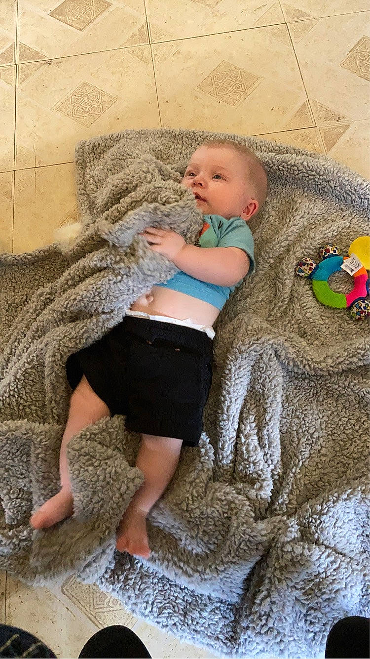 Korbyn joined the competition — help win amazing prizes! baby, barefoot, child, comfort, flooring, foot, fun, fur, grey, human_leg, leg, leisure, linens, pattern, person, sitting, textile, thigh, toddler, trunk